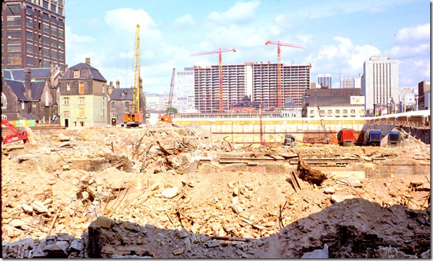 View of Eaton's demolition in foreground, Scadding House and office buildings in background – September 7, 1974